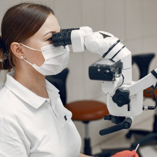 female-doctor-medical-mask-doctor-conducts-examination-woman-conducts-microbiological-study_1157-40936